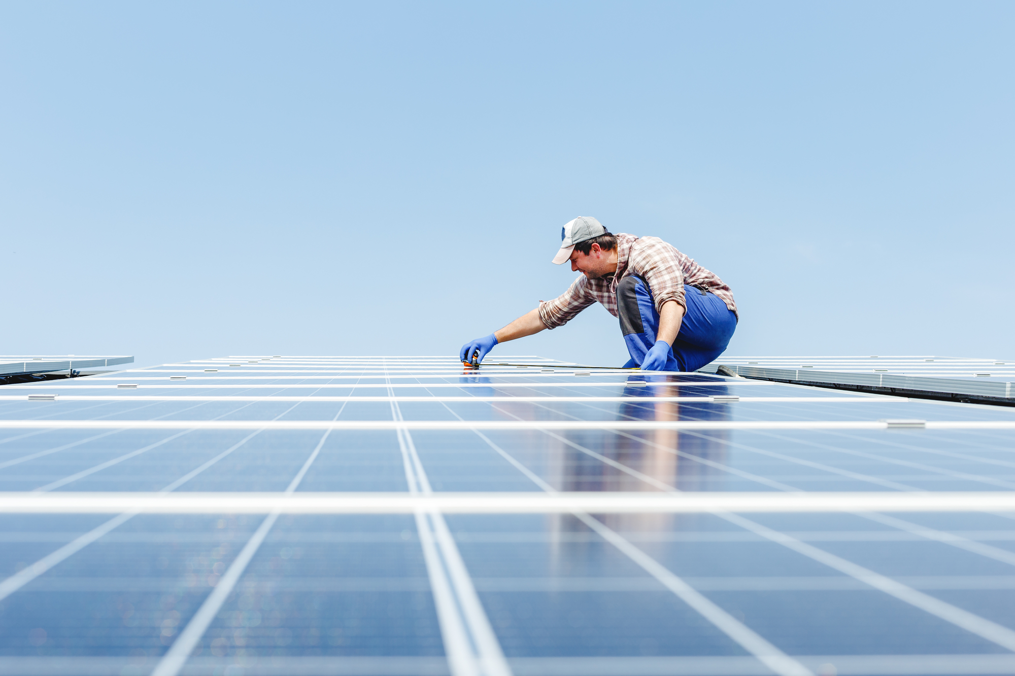 A Person Working On A Solar Panel